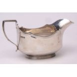 George VI gravy boat of polished oval form with applied and shaped rim and handle on spreading