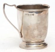 George VI christening mug of plain polished form with strap work handle on spreading foot, height