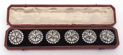 Cased set of six paste and base metal mounted dress buttons, each set with six triangular mounts