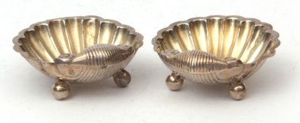 Two late Victorian shell salts each of typical form and raised on three ball feet, width 5.2cms,