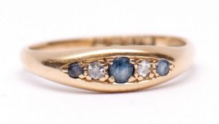 Early 20th century 18ct gold sapphire and diamond ring, boat shaped, alternate set with three