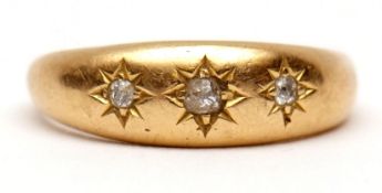 Early 20th century 18ct gold and three-stone diamond ring, the plain polished band set with three