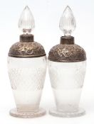Two George V silver mounted and clear glass spirit decanters, each with slice cut spire stoppers