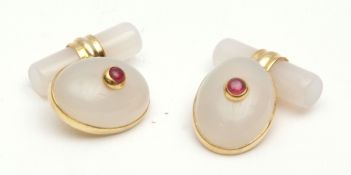 Pair of modern chalcedony and ruby cuff links of oval cabochon shape with collet set small ruby