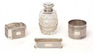 Mixed Lot: three various silver napkin rings, together with a silver lidded and moulded clear