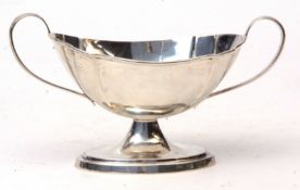 George V two-handled sugar basin of oval form with applied handles on a spreading oval foot, width