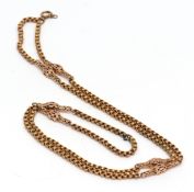 Vintage yellow metal chain, having circular ribbed links with lantern shaped spacers between (a/