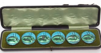 Early 20th century cased set of six base metal and enamelled buttons, each decorated with lily