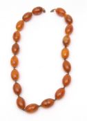 Vintage Bakelite amber colour bead necklace, uniform oblong shape beads, (25mm approx), partly