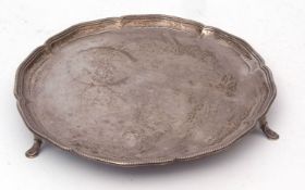 George V small salver of shaped circular form with beaded rim and raised on three feet, width 20 1/2