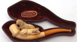 Late 19th century cased Meerschaum pipe, the bowl decorated with two dogs to an amber coloured