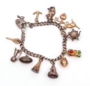White metal curb link bracelet, suspending five 9ct gold and one 585 stamped charms, to include a