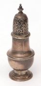 Table caster of baluster form with pierced pull off cover and cast and applied finial, on a