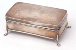 George V dressing table casket of hinged rectangular form with domed cover and raised on four paw