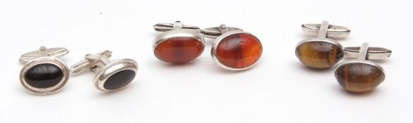 Mixed Lot: three pairs of modern cuff links, each in oval shaped onyx cornelian and tiger's eye
