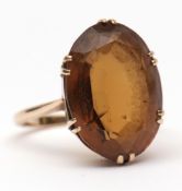 Modern yellow metal and citrine dress ring, the large oval shaped faceted citrine (18 x 12mm),