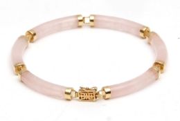 Modern yellow metal and pink jade articulated bracelet, the six cylindrical jade links each capped