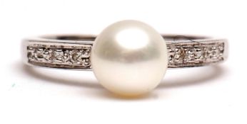 Modern precious metal diamond and pearl ring, the cultured pearl (6mm diam) raised between diamond