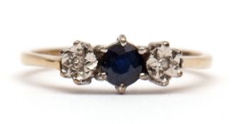 Modern 9ct gold diamond and sapphire ring, the central circular faceted sapphire between two small