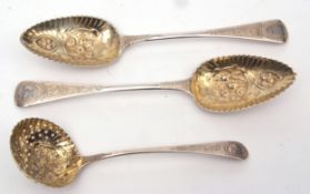Two George III Old English pattern table spoons, later converted to gilt highlighted berry spoons