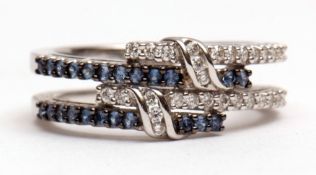Modern precious metal diamond and sapphire cluster ring, a stylised design of entwined split bands
