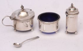 George V three-piece cruet set comprising lidded mustard, open salt and pepper caster, each of plain