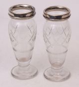 Two George V silver mounted and clear cut glass baluster vases, each with plain polished and applied