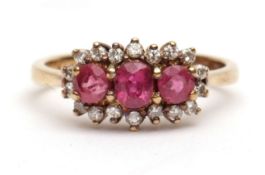 Precious metal diamond and pink stone cluster ring, a row of three graduated pink stones within a