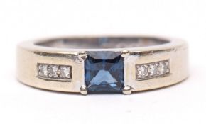 Modern 9ct white gold blue stone and diamond ring, the centre Princess cut stone claw set between