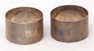 Two Elizabeth II napkin rings, each of cylindrical form with all over engine turned decoration and