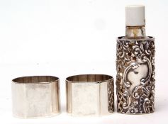 Mixed Lot: pair of three-quarter round plain and polished cylindrical napkin rings, together with