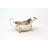 George V sauce boat with cut card rim, strapwork handle on three feet, length 14.8cms, weight approx