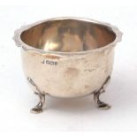 George V small bowl of polished form with cut card rim and raised on three cast feet, width 8 1/2