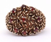 9ct gold and garnet cluster ring, heavily textured design set with 9 small circular cut garnets,