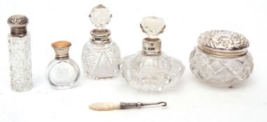 Mixed Lot: two silver lidded perfume flasks, together with three further clear cut glass and