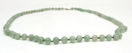 Celadon jade bead necklace, single row of uniform beads (8mm diam) with tied knots between, 49cms