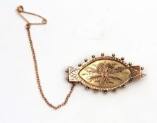 Victorian 9ct two-tone gold brooch, engraved and chased with a shield and spear design, having a