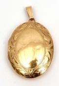 Modern 9ct gold locket, oval shaped, the front engraved and chased with a border of scrolls, 30 x