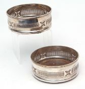 Pair of late 19th century silver on copper bottle coasters, each of typical circular form with