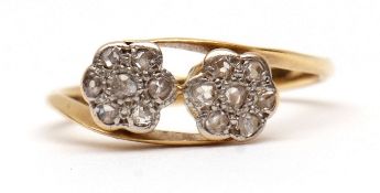 Precious metal and small diamond cross-over ring, two flowerheads each set with seven small rose cut