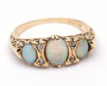 18ct gold opal and diamond ring, boat shaped, having three graduated opals interspersed with small