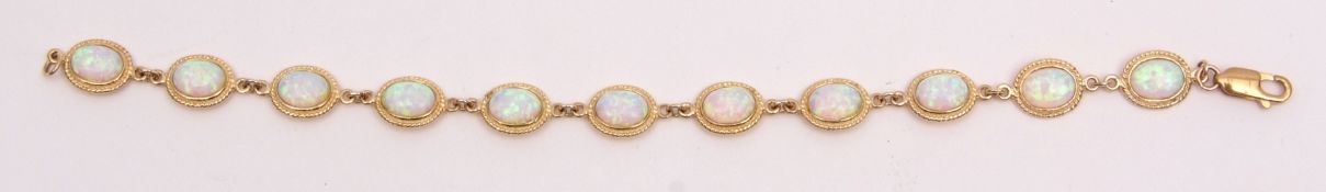 Modern yellow metal and opalescent bracelet comprising 11 oval cabochon opalescents, collet set in