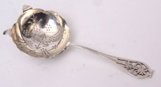 Elizabeth II tea strainer with pierced handle and shaped and pierced circular bowl, length 15cms, wt