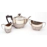 Early 20th century electroplated three-piece tea set of oval half fluted form, comprising tea pot,