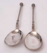 Two Victorian ice cream serving spoons, each with pear shaped bowls with cast handles with mask