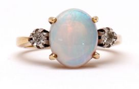 Precious metal opal and diamond ring, the central opal (12 x 8mm) set between two small circular cut