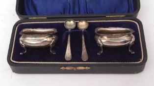 Cased pair of George V open salts each of rectangular form and raised on four cast and applied feet,