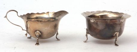 Edward VII sugar basin and milk jug, each with cut card rims and raised on applied feet, combined