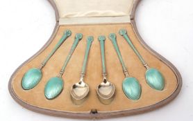 Cased set of six George V Continental silver gilt and enamelled coffee spoons, with pale blue