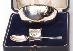 Cased christening set comprising a plain polished bowl, small single spoon and napkin ring, combined
